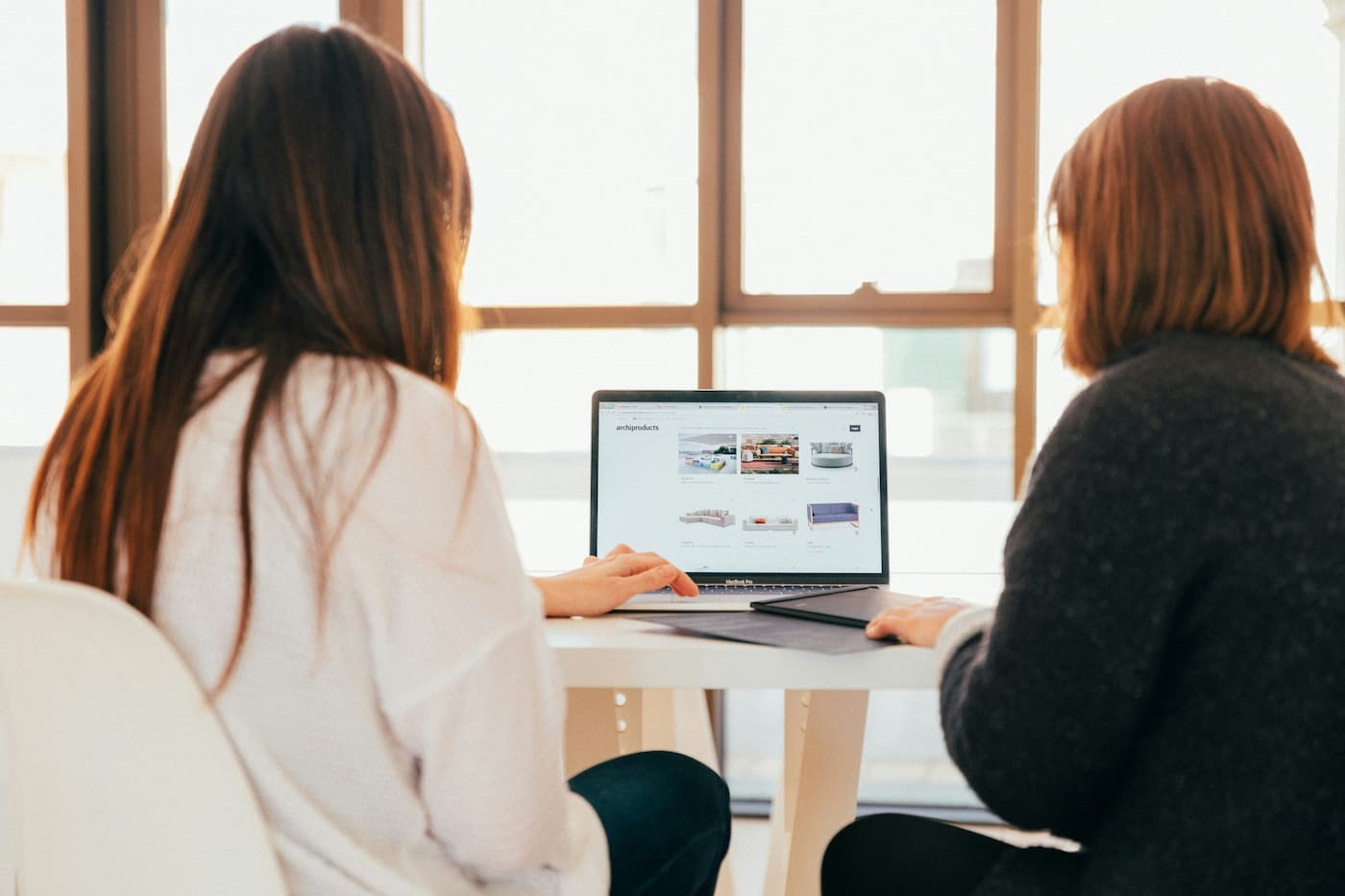 Two women reviewing ecommerce site