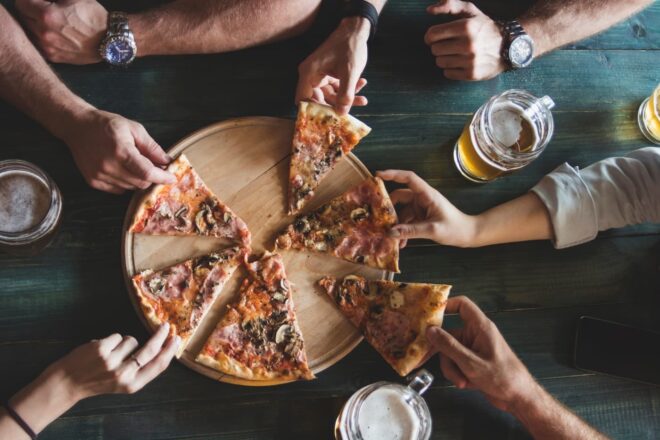 Group eating pizza and drinking beer