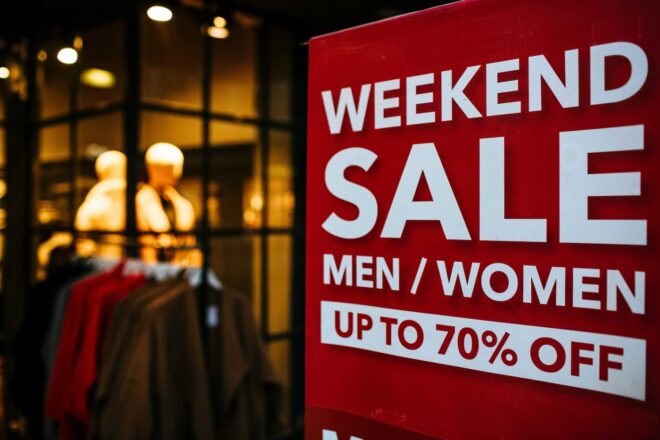 Red weekend sale sign outside a clothing store