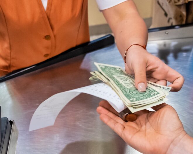 Cashier handing cash back to customer