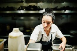 Female chef preparing food in a commercial kitchen