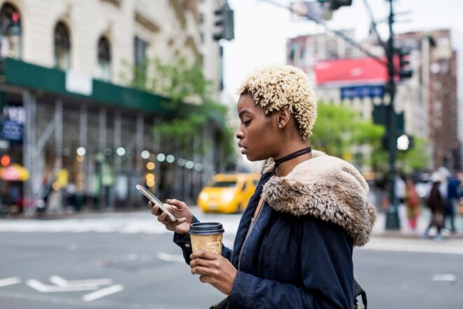 Woman walking in the city looking at phone
