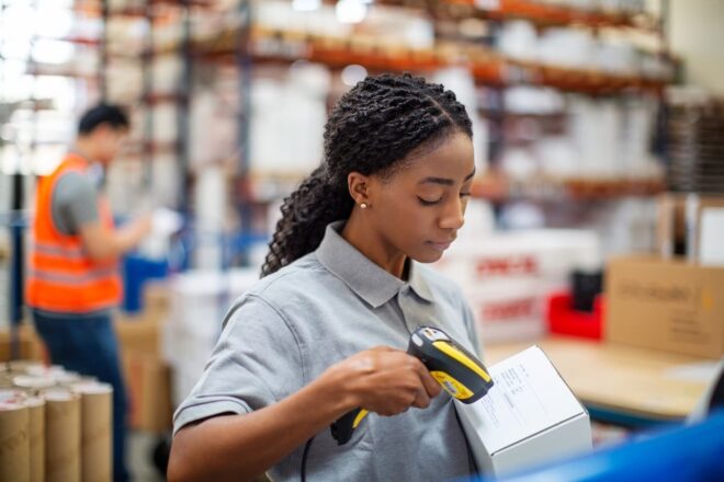 Female worker scanning a box in a warehouse