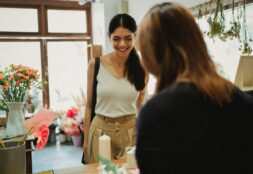 Florist welcoming her customer into her shop