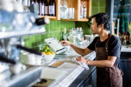 restaurant worker entering order into POS system