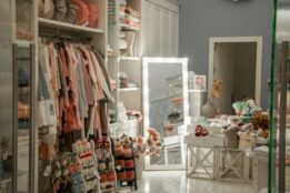 Interior view of a small boutique with clothing, shoes, and home decor