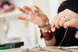 woman making jewelry to sell online