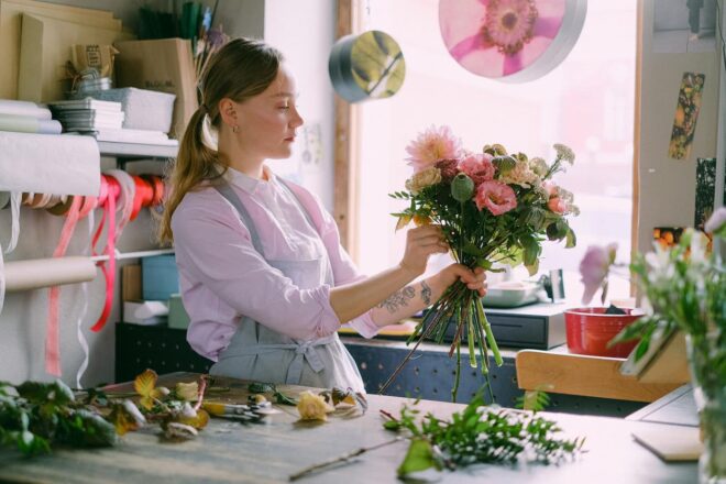 Florist arranging flowers in her shop