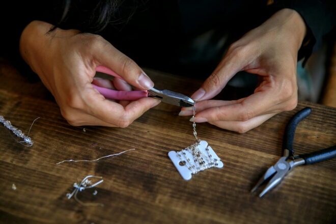 Jeweler using pliers to make a necklace