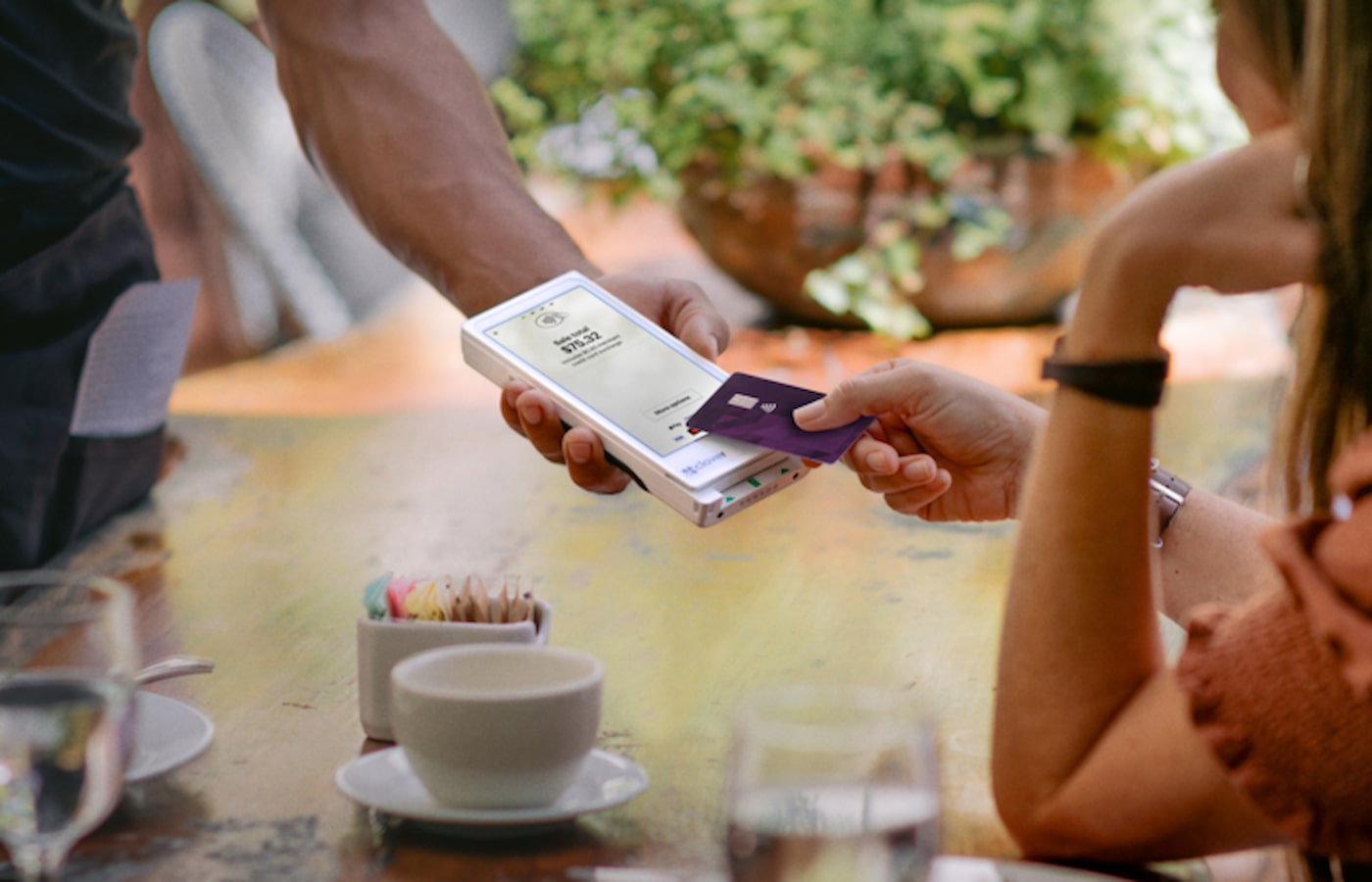 Server using Clover Flex Pocket to collect credit card payment from customer