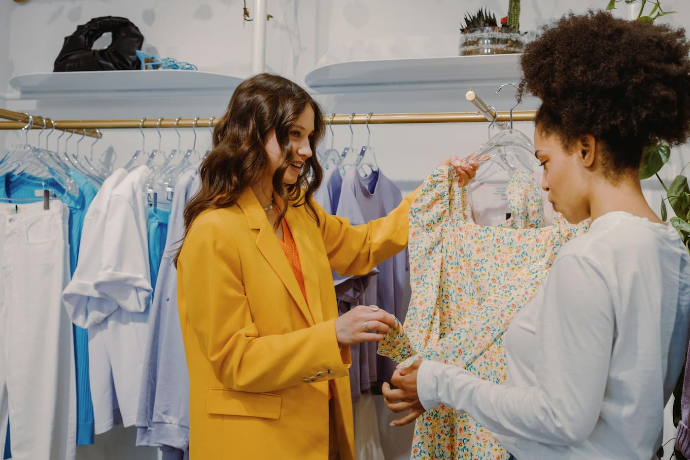 Boutique stylist helping customer select outfit