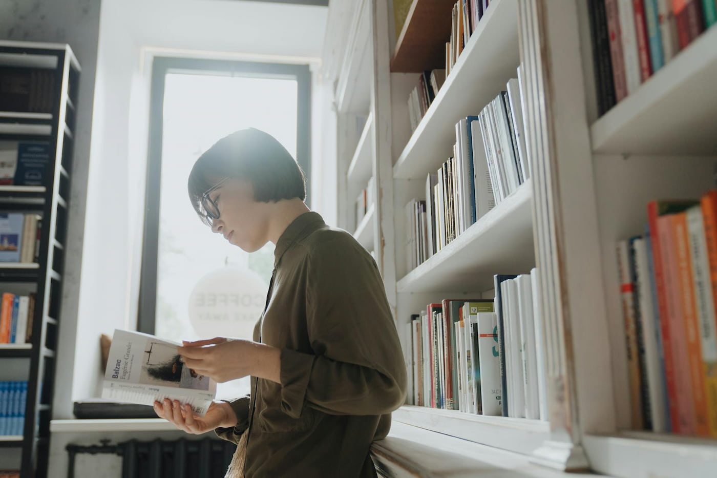 Woman reading book in a bookstore