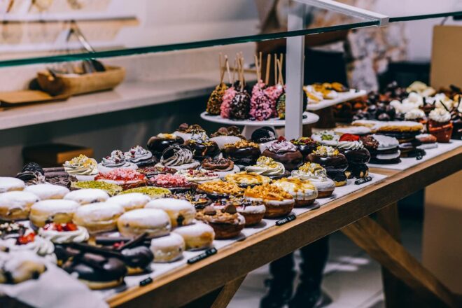 Display case filled with a variety of colorful baked goods and pastries