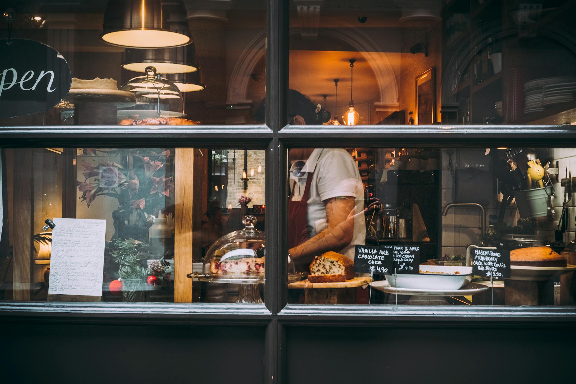 View of bakery and baker through the bakery's front window