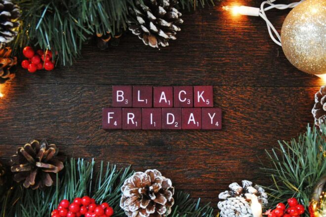 Black Friday spelled out in Scrabble pieces on a holiday background