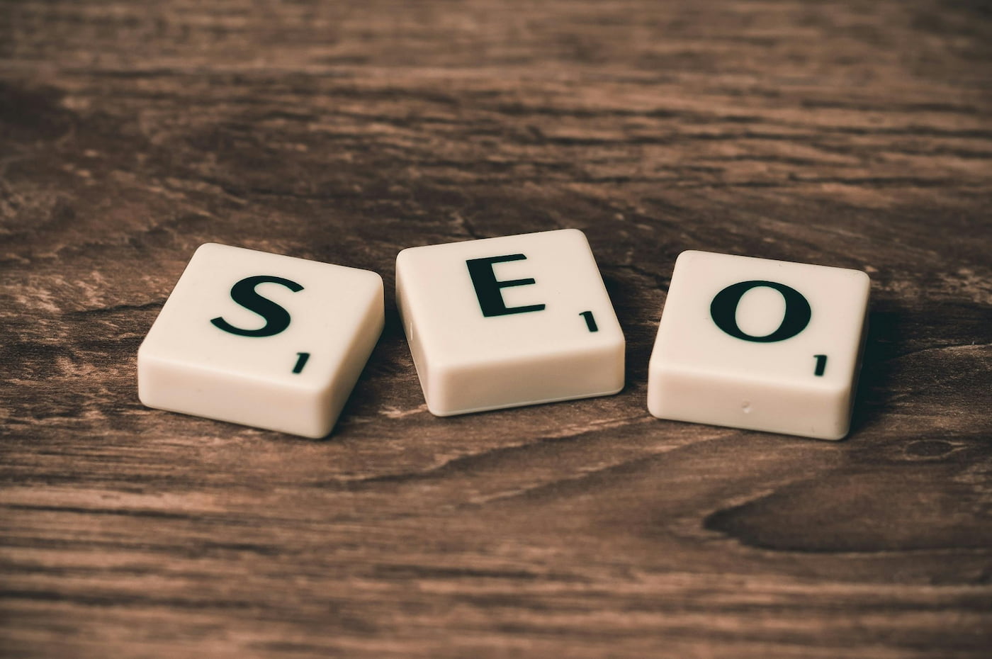 Scrabble pieces on a table spelling out SEO