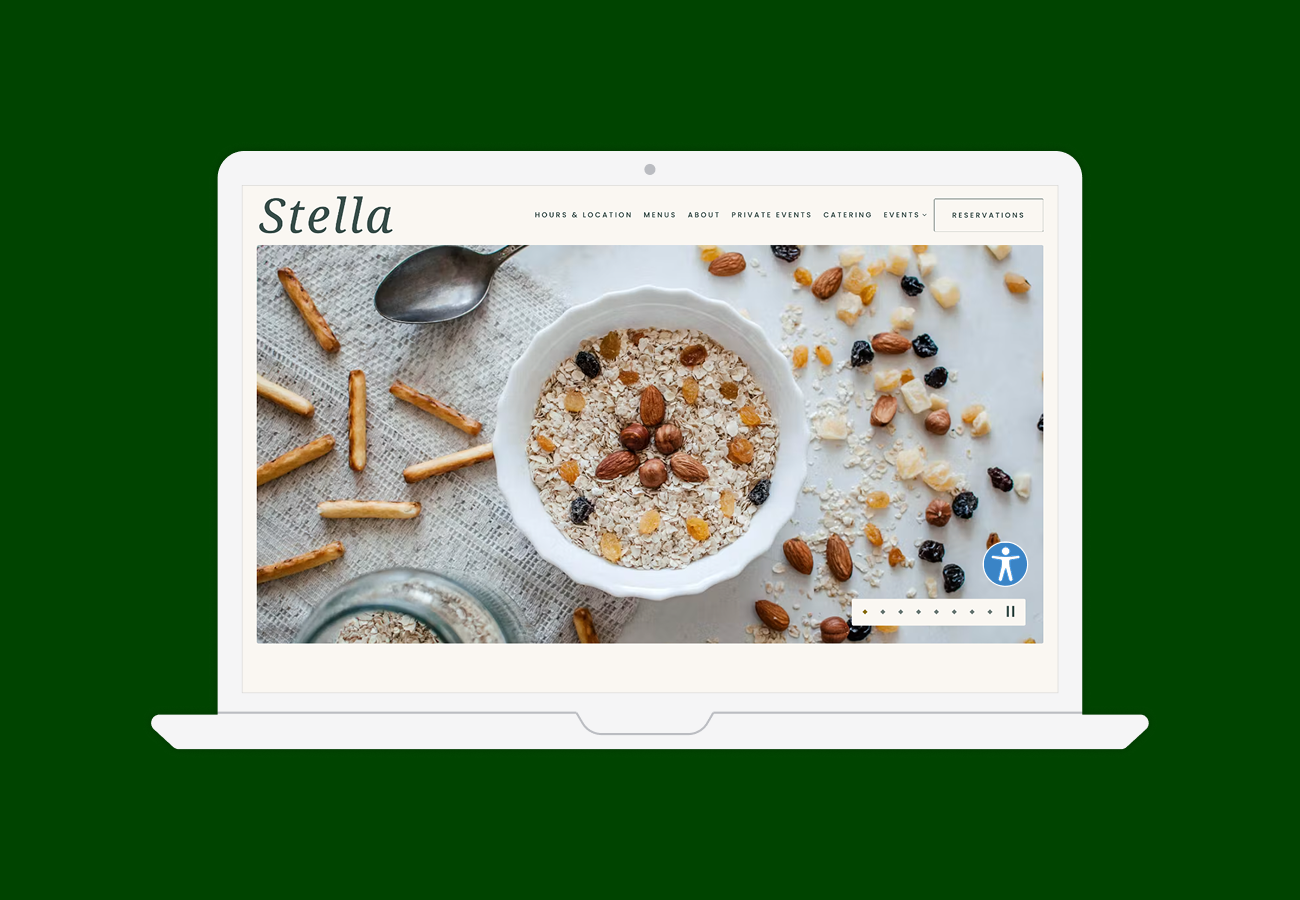 A laptop screen displaying the Stella restaurant website homepage
