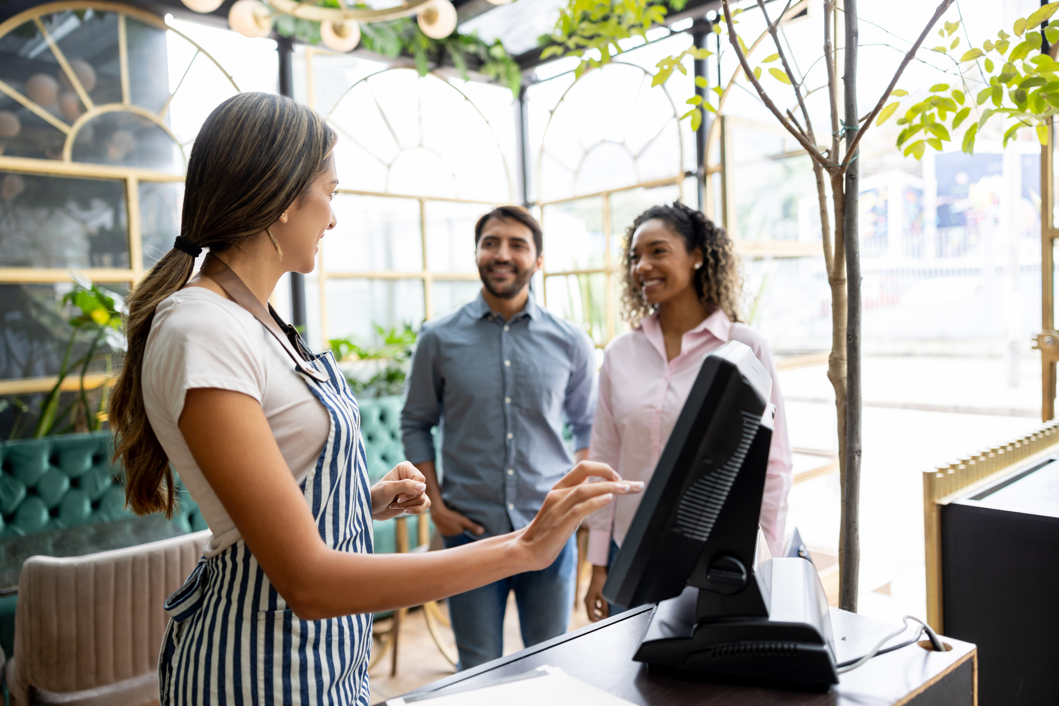 Waitress welcomes couple to a restaurant reservation